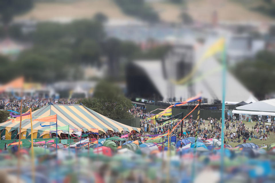 People walk round the Glastonbury Festival site