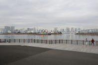 The Olympic rings are seen at the empty Odaiba waterfront in Tokyo, Tuesday, Jan. 26, 2021. The Tokyo Games, postponed in the midst of a pandemic, are scheduled to open on July 23. (AP Photo/Koji Sasahara)