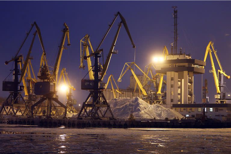 FILE - Harbor cranes are seen in Mariupol trade port in Mariupol, south coast of Azov sea, eastern Ukraine, Sunday, Dec. 2, 2018. Andrey Stavnitser, CEO of the port operator TIS Group said the Black Sea ports are operating as usual for now, but it's only a matter of time before the same insurance problems that cut off commercial flights start to hit the shipping industry. Ukraine is one of the world's top grain exporters, loading container ships that carry 12% of the world's wheat supply and 16% of its corn. (AP Photo/Efrem Lukatsky, File)