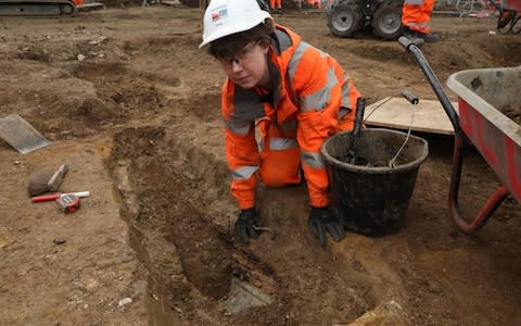 Archaeologists work on the HS2 project in St. James's burial ground, Euston - Credit: PA