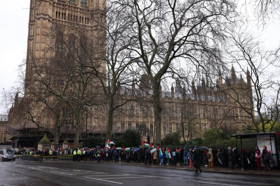 People with Palestinian flags queued to get into parliament for the Gaza vote (Getty Images)