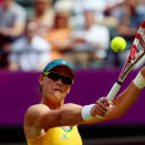 LONDON, ENGLAND - JULY 28: Samantha Stosur of Australia returns a shot against Carla Suarez Navarro of Spain during her Women's Singles Tennis match on Day 1 of the London 2012 Olympic Games at the All England Lawn Tennis and Croquet Club in Wimbledon on July 28, 2012 in London, England. (Photo by Phil Walter/Getty Images)