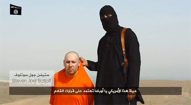 A masked Islamic State militant speaks next to a man purported to be US journalist Steven Sotloff at an unknown location in this still image. Photo: Reuters