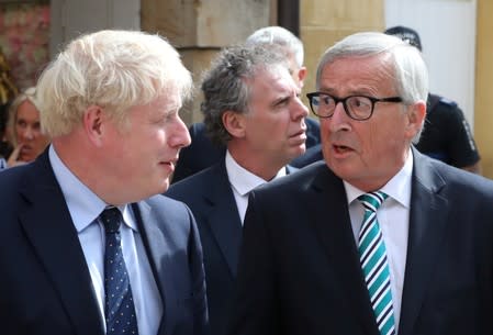 British Prime Minister Boris Johnson and European Commission President Jean-Claude Juncker talk as they leave after their meeting in Luxembourg