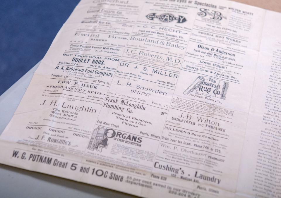 Advertising for long-gone Peoria-area businesses fill one page of a church newspaper found inside the time capsue of Hale Memorial Church.