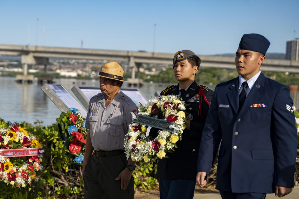 Servicemen and a Park Service ranger present a wreath during the 82nd Pearl Harbor Remembrance Day ceremony on Thursday, Dec. 7, 2023, at Pearl Harbor in Honolulu, Hawaii. (AP Photo/Mengshin Lin)