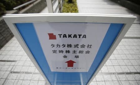 A sign board of Japanese auto parts maker Takata Corp's Annual General Meeting is seen on a street near the venue in Tokyo June 26, 2014. REUTERS/Yuya Shino