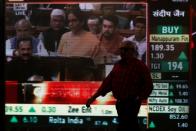 Man walks past a telecast of India's Finance Minister Nirmala Sitharaman presenting the budget inside the Bombay Stock Exchange (BSE) building in Mumbai