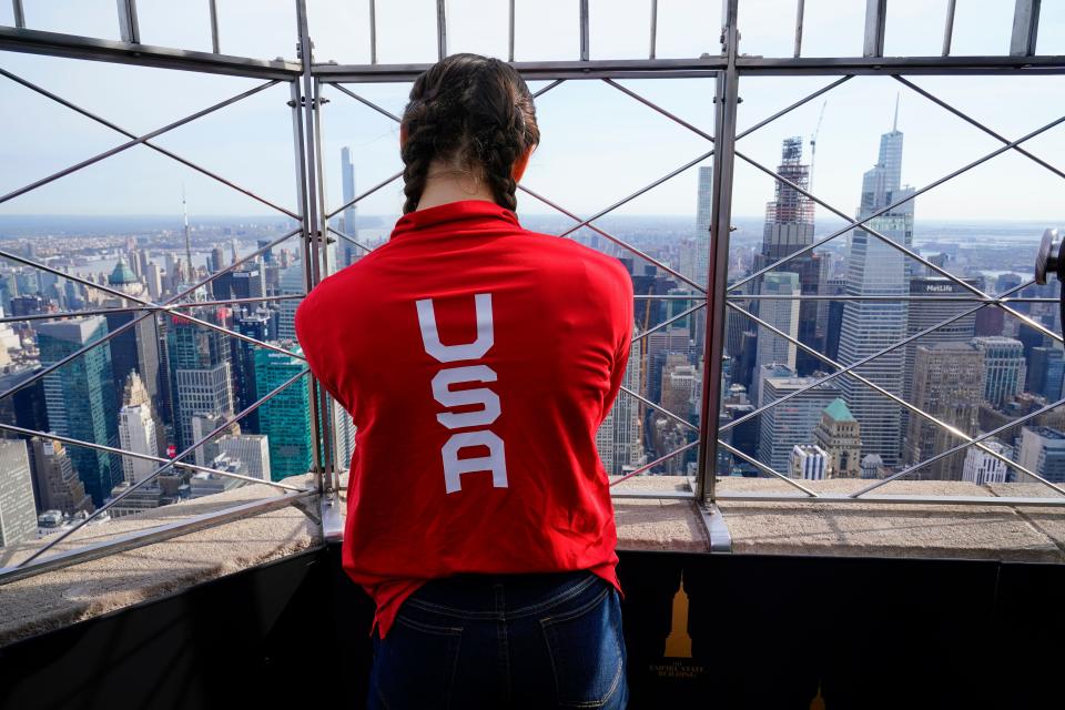 Team USA athlete Evita Griskensas looks out from the 85th floor observation deck of the Empire State Building in New York City on April 17 during a 100 days out to Paris 2024 Olympic Games event. Griskensas is a rhythmic gymnast on the U.S. Olympic Team.