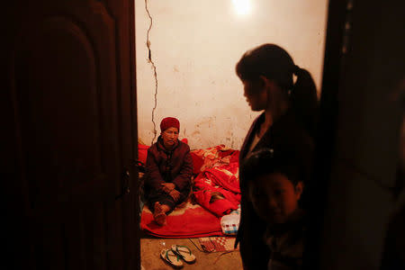 Refugees who fled fighting in neighbouring Myanmar sit in the house of a relative in the village of Baiyan near Nansan in the Yunnan province, China, March 11, 2017. REUTERS/Thomas Peter