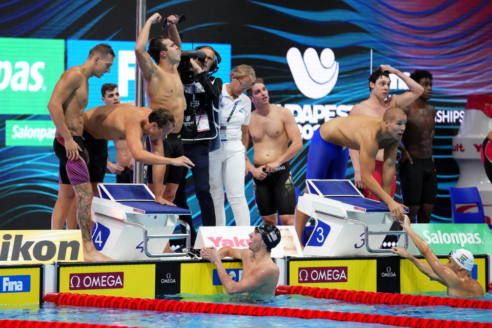 Members of team United States celebrate after winning the men's 4x100m freestyle relay final at the 19th FINA World Championships in Budapest, Hungary, Saturday, June 18, 2022. (AP Photo/Petr David Josek)