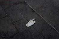 A sanitary glove lies on the pavement of a deserted street just after nationwide confinement measures came into effect, Tuesday, March 17, 2020, in Marseille, southern France. French President Emmanuel Macron announced strong restrictions on freedom of movement in a bid to counter the new coronavirus, as the European Union closed its external borders to foreign travelers. For most people, the new coronavirus causes only mild or moderate symptoms. For some it can cause more severe illness. (AP Photo/Daniel Cole)