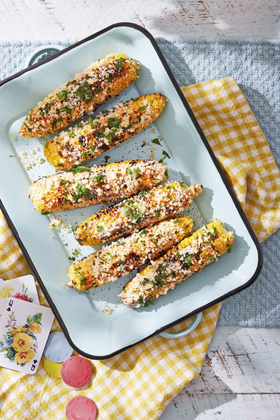 mexican street corn arranged on a light blue serving tray