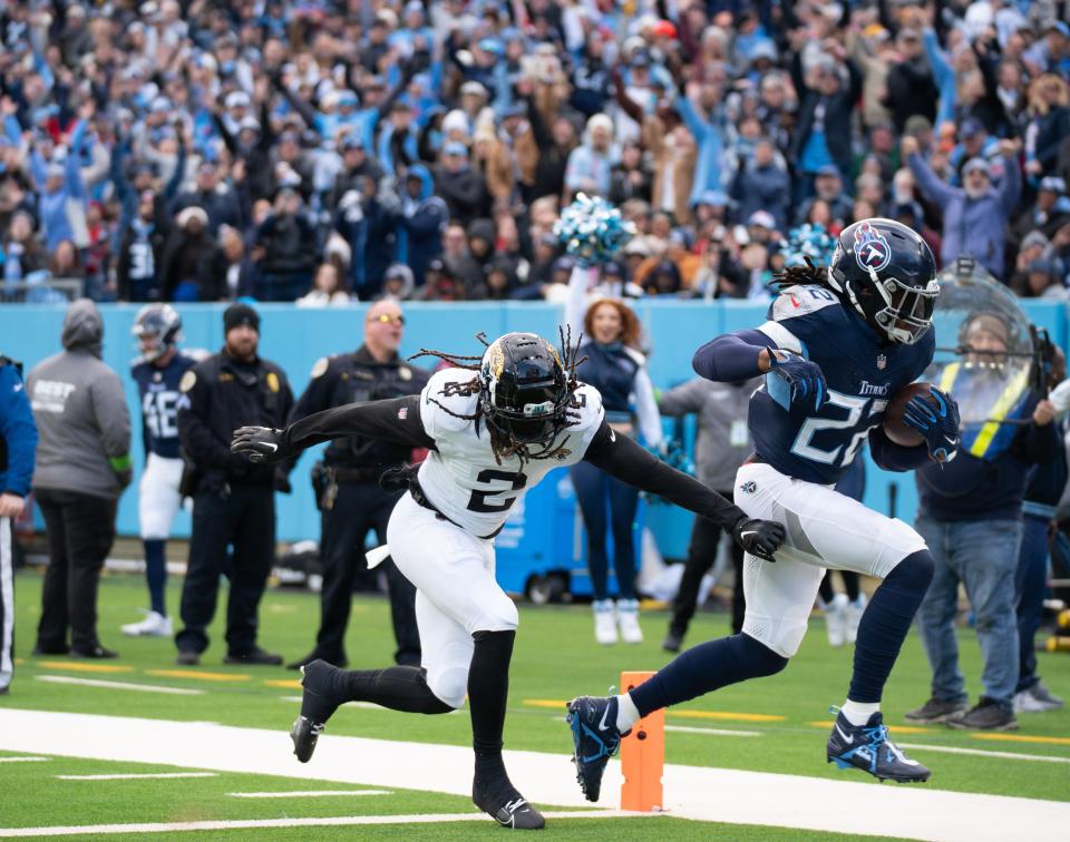 Tennessee Titans running back Derrick Henry (22) runs past Jacksonville Jaguars safety Rayshawn Jenkins (2) for a touchdown in the second quarter of their game at Nissan Stadium in Nashville on Sunday.