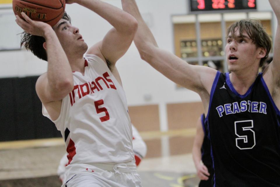 Jim Ned senior Xavier Wishert attempts an inside shot against Peaster's Noah Drenth in an area playoff game Thursday. Peaster pulled out a 48-46 win.