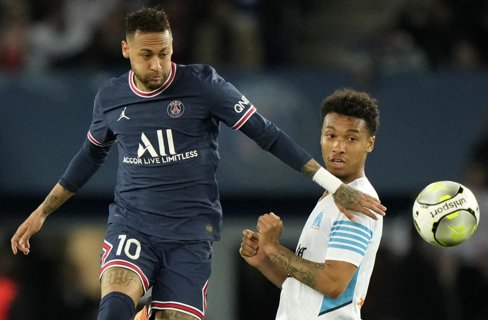 PSG's Neymar, left, kicks the ball during the League One soccer match between Paris Saint Germain and Marseille, at the Parc des Princes stadium, in Paris, France, Sunday, April 17, 2022. (AP Photo/Francois Mori)