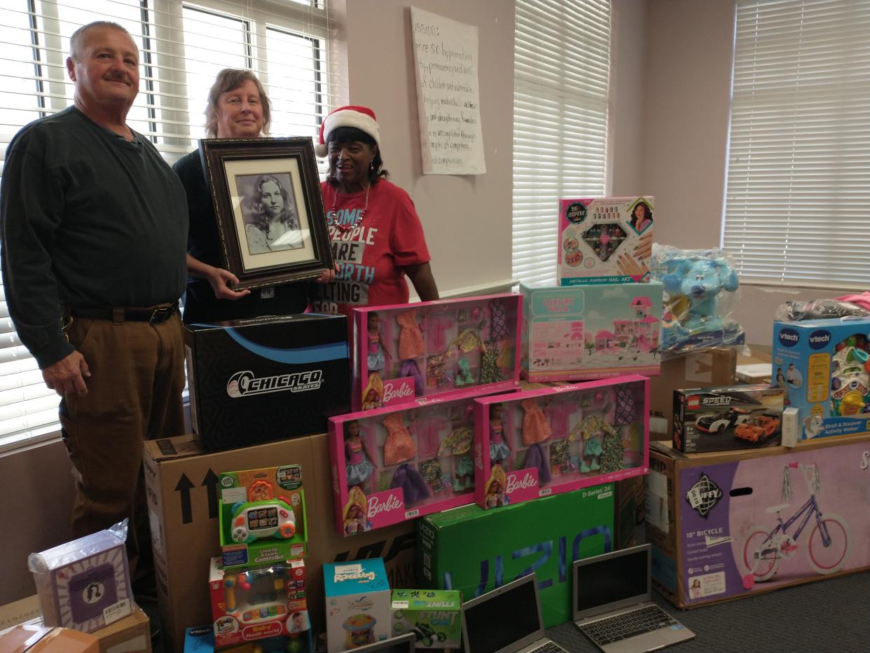 Family members of the late Gloria Harriott Satterfield delivered Christmas gifts from the Gloria's Gift Foundation to the Hampton County Department of Social Services' Fill the Stocking campaign. From left are Wade Hadwin, Ginger Harriott Hadwin, and Evon Williams, retired Child Welfare Specialist at DSS.
