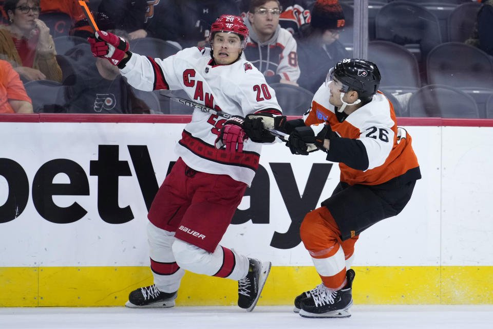 Carolina Hurricanes' Sebastian Aho, left, tries to get past Philadelphia Flyers' Sean Walker during the third period of an NHL hockey game, Monday, Oct. 30, 2023, in Philadelphia. (AP Photo/Matt Slocum)