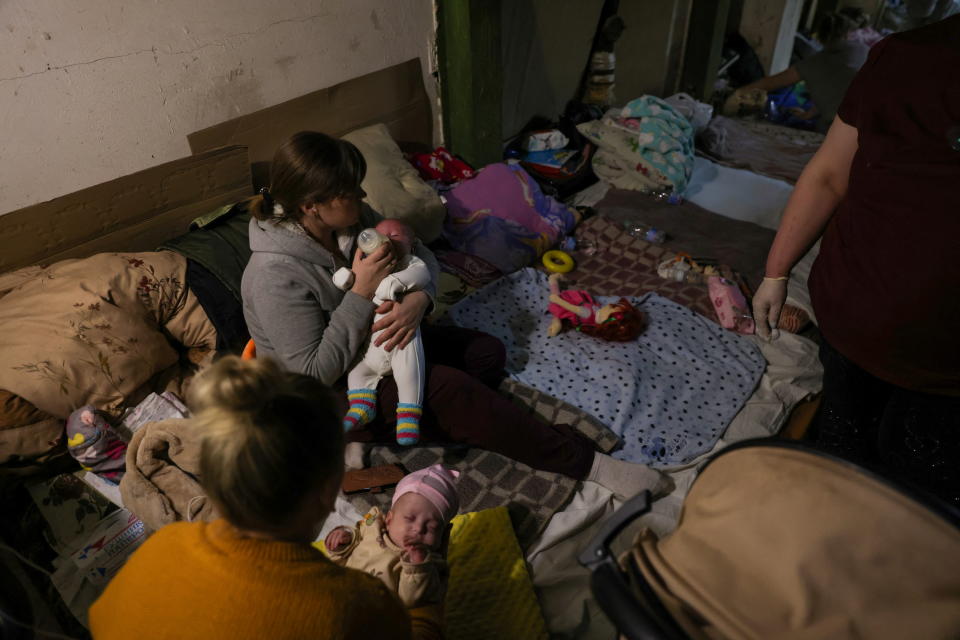 A woman feeds a baby in one of the shelters of Okhmadet Children's Hospital, as Russia's invasion of Ukraine continues, in Kyiv, Ukraine February 28, 2022. REUTERS/Umit Bektas