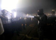 Aug 23, 2020; Kenosha, WI, USA; A protestor shins a flashlight in the direction of Kenosha County Sheriffs Deputies outside the Kenosha Police Department in Kenosha on Sunday, Aug. 23, 2020. Kenosha police shot a man Sunday evening, setting off unrest in the city after a video appeared to show the officer firing several shots at close range into the man's back. Mandatory Credit: Mike De Sisti/Milwaukee Journal Sentinel via USA TODAY NETWORK/Sipa USA