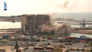 This screen grab obtained from a handout video released by the Lebanese Broadcasting Corporation International (LBCI) shows parts of Beirut's grain silos collapsing on July 31, 2022, just days before the second anniversary of a catastrophic explosion at the Lebanese capital's port that ravaged the stores and swathes of the city. - The silos complex had absorbed much of the impact of the August 4, 2020 mega-blast at the port that killed more than 200 people and injured over 6,500. The partial collapse came after fire broke out at the silos earlier this month, caused by fermentation of remaining grain stocks along with soaring summer temperatures, according to authorities. (Photo by LBCI / AFP) / RESTRICTED TO EDITORIAL USE - MANDATORY CREDIT 