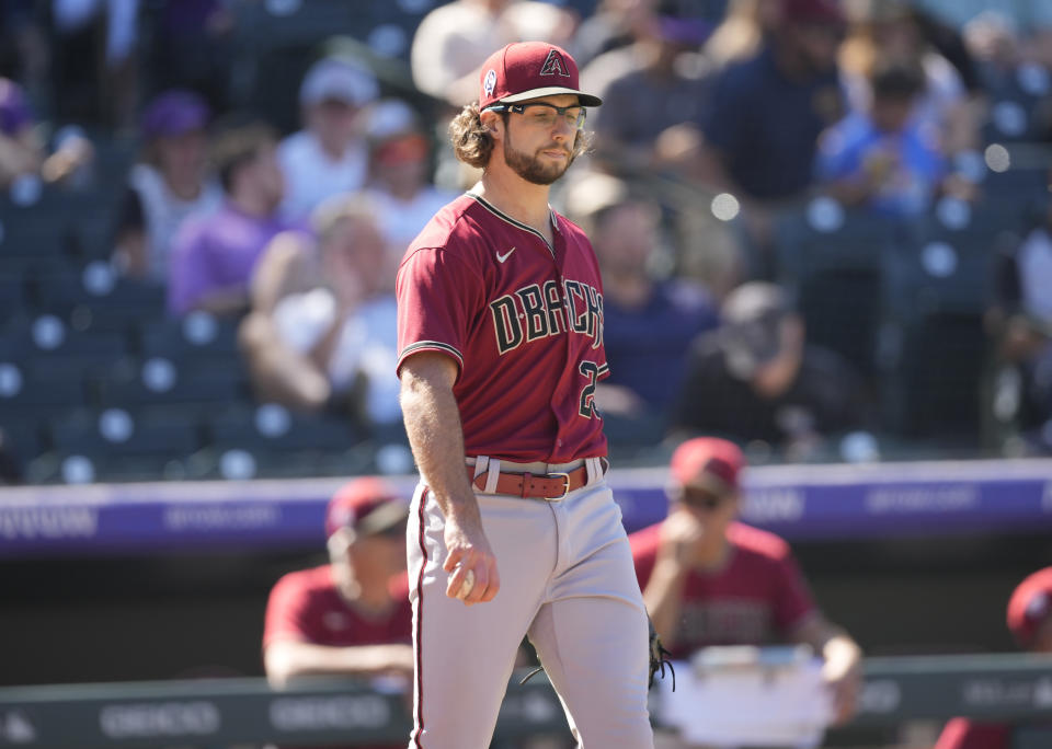 Arizona Diamondbacks starting pitcher Zac Gallen reacts after giving up an RBI-single to Colorado Rockies' C.J. Cron in the fourth inning of a baseball game Sunday, Sept. 11, 2022, in Denver. (AP Photo/David Zalubowski)