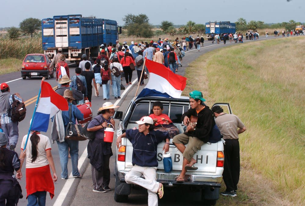 Paraguayans from the town of Puerto Casado take part in a 91-mile march from their homes towards Asuncion, the capital, to pressure the government to turn over some of the land acquired in their region by the Unification Church for subsistence farming, in Tacuara, Paraguay, on July 16, 2005. <span class="copyright">Rene Gonzalez—Reuters</span>