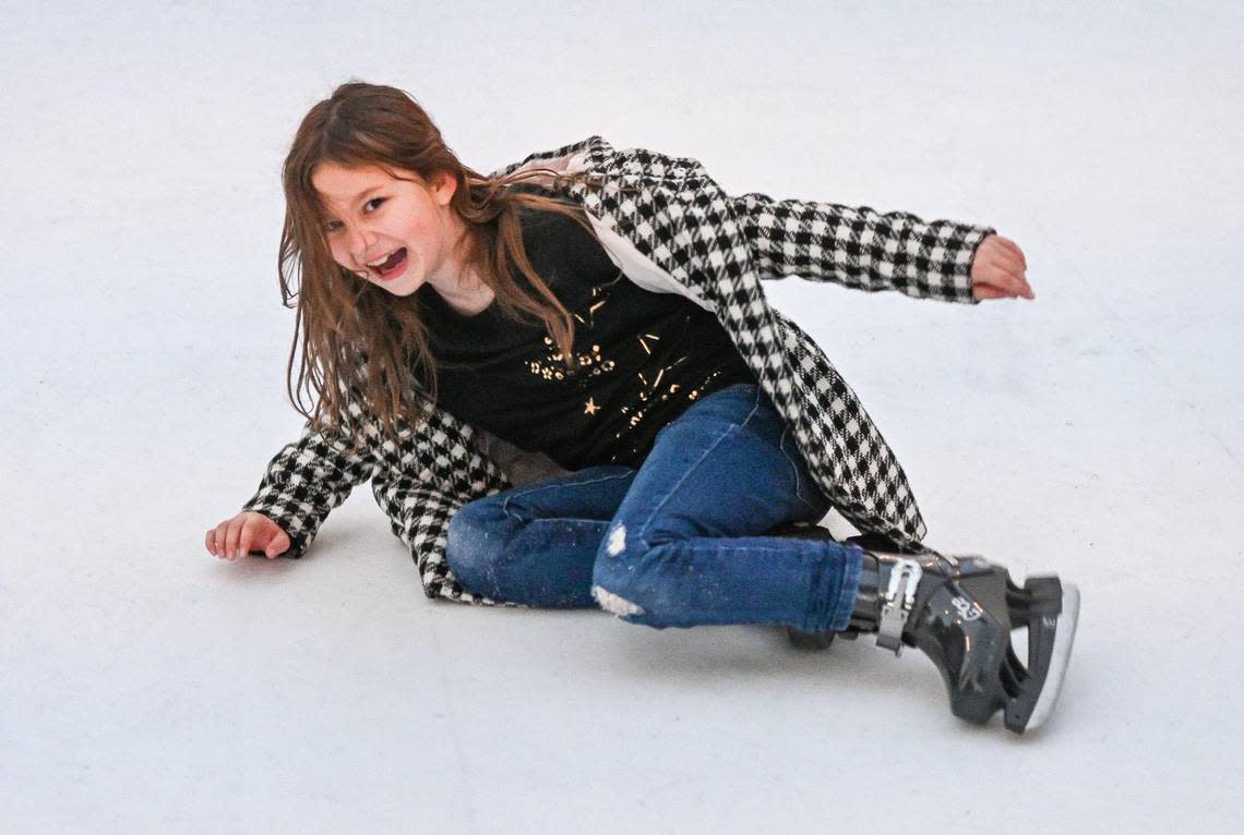 Violet Wyatt, 9, of Fresno takes a spill while enjoying her first time skating on the new skate rink at The Pines Resort on Bass Lake on Wednesday, Dec. 28, 2022.