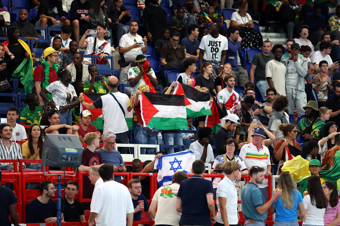 PARIS, FRANCE - JULY 24: Fans hold the Palestine flag during the Men's group D match between Mali and Israel during the Olympic Games Paris 2024 at Parc des Princes on July 24, 2024 in Paris, France. (Photo by Maja Hitij/Getty Images)