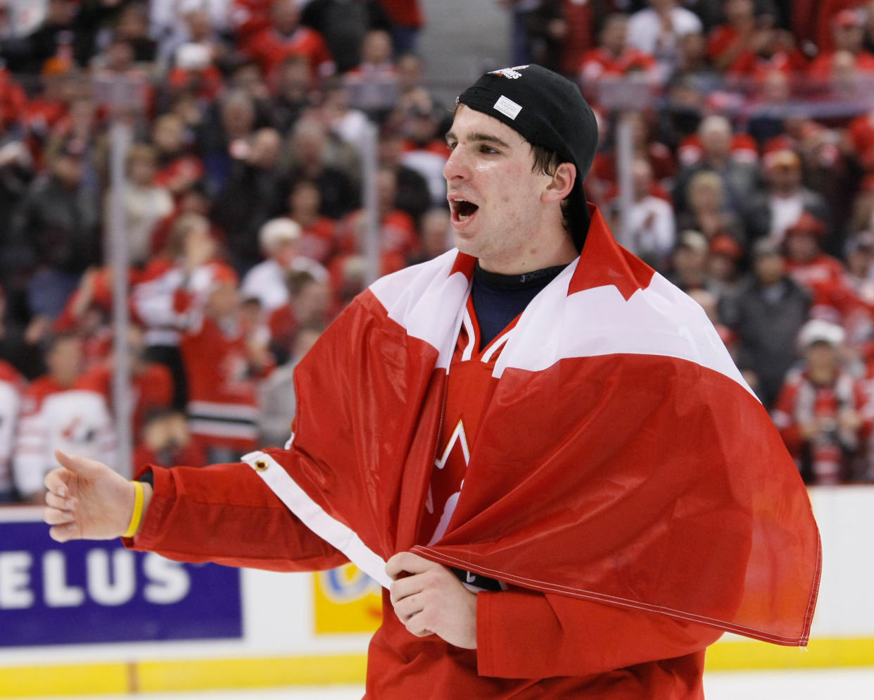 OTTAWA, ON - JANUARY 5:  John Tavares #19 of Team Canada skates with a Canadian flag wrapped around him during post game ceremonies after defeating Team Sweden at the Gold Medal Game of the IIHF World Junior Championships at Scotiabank Place on January 05, 2009 in Ottawa, Ontario, Canada.  Team Canada defeated Team Sweden 5-1.  (Photo by Richard Wolowicz/Getty Images)