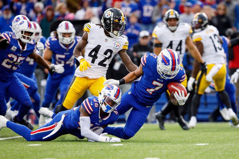 Buffalo Bills cornerback Taron Johnson (7) recovers a fumble by Pittsburgh Steelers cornerback James Pierre (42) during an NFL football game, Sunday, Oct. 9, 2022, in Orchard Park, NY. (AP Photo/Matt Durisko)