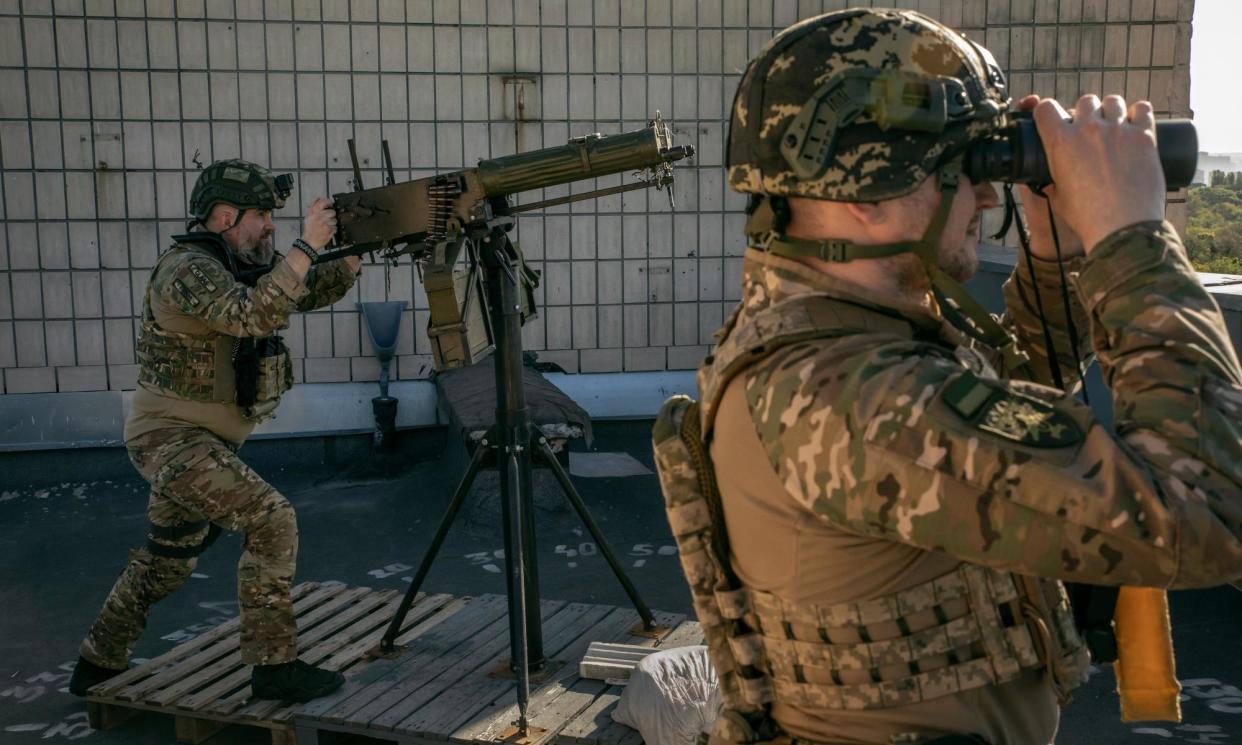 <span>Yevhen Miezientsev (left) and Mykola Misechko on top of a high-rise apartment block in Kyiv.</span><span>Photograph: Alessio Mamo/The Guardian</span>