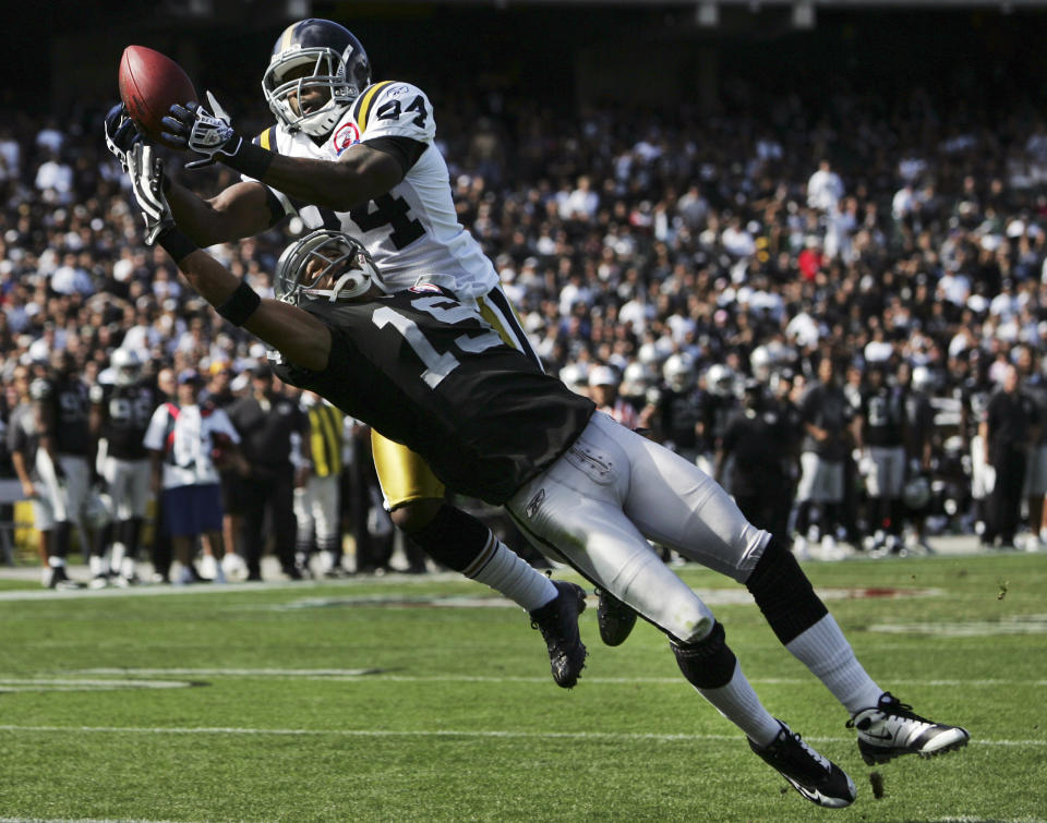 FILE - New York Jets cornerback Darrelle Revis, top, intercepts a pass in the end zone intended for Oakland Raiders wide receiver Todd Watkins during the first quarter of an NFL football game Oct. 25, 2009, in Oakland, Calif. Revis is in the conversation about greatest cornerbacks in NFL history especially after his 2009 season during which he shut down the likes of Randy Moss, Chad Johnson, Andre Johnson, Steve Smith, Terrell Owens, Reggie Wayne and Roddy White. (AP Photo/William Cooley, File)