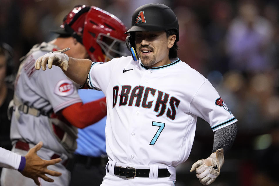 Arizona Diamondbacks' Corbin Carroll crosses the plate after hitting a two run home run against the Cincinnati Reds during the eighth inning of a baseball game, Thursday, Aug. 24, 2023, in Phoenix. (AP Photo/Matt York)