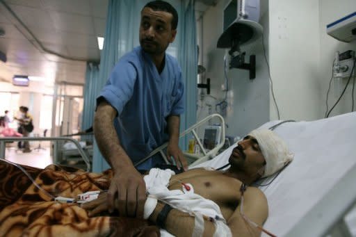 A Yemeni medic tends to an injured fighter loyal to Yemeni tribal chief Sadiq al-Ahmar at a hospital in Sanaa. Security forces in the Yemeni capital battled heavily armed supporters of the country's most powerful tribal leader on Thursday as President Ali Abdullah Saleh ordered the tribesman's arrest