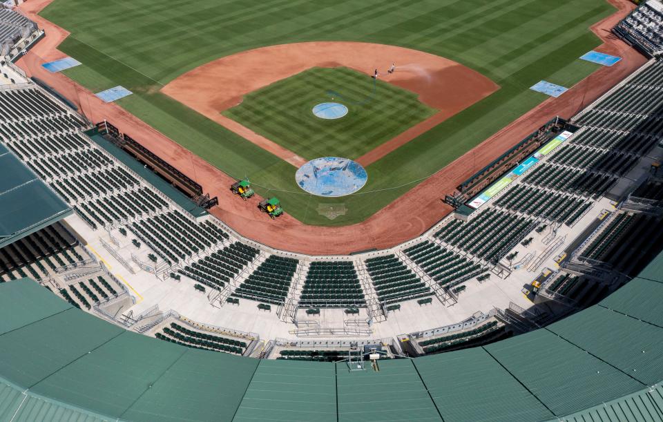 Grounds crew members keep the field in shape at Roger Dean Chevrolet Stadium last week while the MLB lockout continued. With a new collective bargaining agreement in place, the Marlins and Cardinals will be reporting for spring training and the stadium will be hosting games later this week.