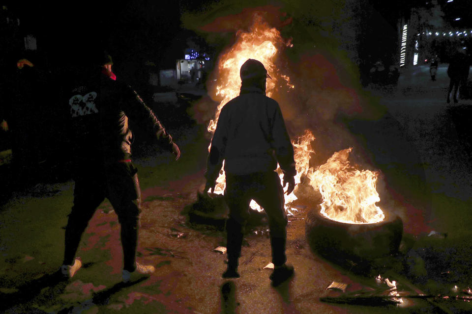 Supporters of former Prime Minister Saad Hariri burn tires to block a main road in Beirut, Lebanon, Monday, Jan. 24, 2022. On Monday Hariri said he is suspending his work in politics and will not run in May's parliamentary elections. (AP Photo/Bilal Hussein)