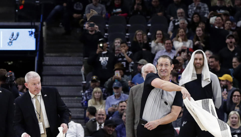 A bat invaded the Spurs’ game against the Pelicans on Saturday, only to be captured by the Spurs mascot hilariously donned in a Batman costume. (AP Photo/Eric Gay)