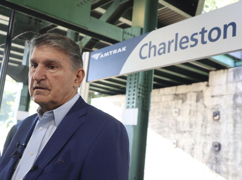 West Virginia Democratic Sen. Joe Manchin speaks with reporters outside the newly renovated Amtrak train station in Charleston, W.Va. on Thursday, Oct. 12, 2023 (AP Photo/Leah Willingham)