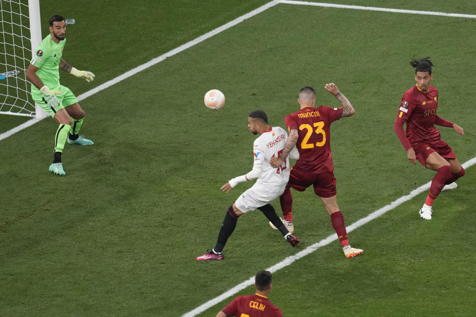 Roma's Gianluca Mancini, number 23, scores an own goal during the Europa League final soccer match between Sevilla and Roma, at the Puskas Arena in Budapest, Hungary, Wednesday, May 31, 2023. (AP Photo/Darko Vojinovic)