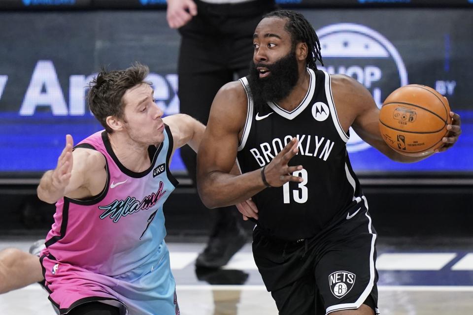 Miami Heat's Goran Dragic, left, defends against Brooklyn Nets' James Harden, right, during the first half of an NBA basketball game Saturday, Jan. 23, 2021, in New York. (AP Photo/Frank Franklin II)