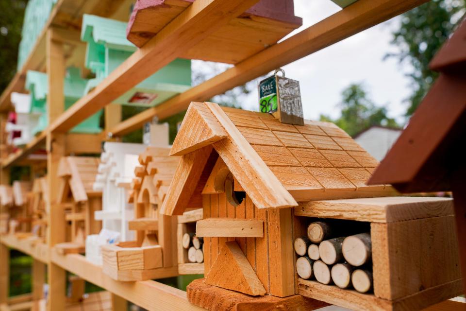 A birdhouse built by Tom Esshaki on display in his driveway in Southfield on Tuesday, July 11, 2023. This particular birdhouse is popular because of the makeshift logs that are featured.