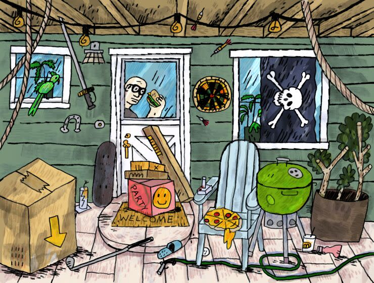 A pirate flag hangs in the window of a house with various party items on the porch. Adam Tschorn peeks out the door window holding a sandwich.