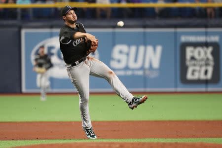 Apr 1, 2019; St. Petersburg, FL, USA; Colorado Rockies third baseman Nolan Arenado (28) throws the ball to first base for an out during the fourth inning against the Tampa Bay Rays at Tropicana Field. Mandatory Credit: Kim Klement-USA TODAY Sports