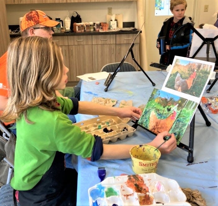 Holmes Center for the Arts homeschool art student Sam Beachy works on an acrylic painting during class at HCA last year.