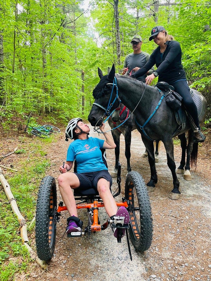Adaptive mountain biker and meets up with equestrians.