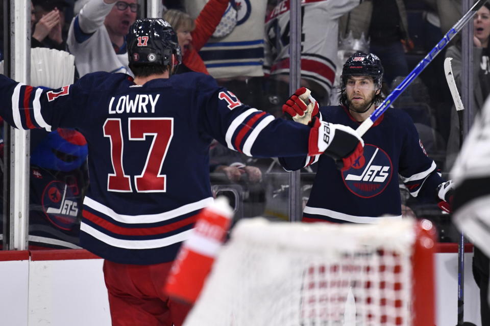 Winnipeg Jets' Kevin Stenlund celebrates his goal against the Los Angeles Kings with Adam Lowry (17) during the second period of an NHL hockey game in Winnipeg, Manitoba, on Tuesday, Feb. 28, 2023. (Fred Greenslade/The Canadian Press via AP)