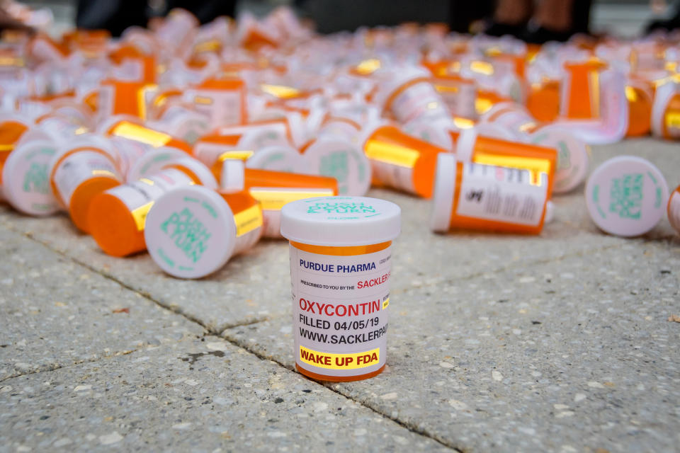 PURDUE PHARMA, STAMFORD, CT, UNITED STATES - 2019/09/12: Members of P.A.I.N. (Prescription Addiction Intervention Now) and Truth Pharm staged a protest on September 12, 2019 outside Purdue Pharma headquarters in Stamford, over their recent controversial opioid settlement. Participants dropped hundreds prescription bottles of OxyContin while holding tombstones with the names of opioids casualties and banners reading "Shame on Sackler" and "200 Dead Each Day". (Photo by Erik McGregor/LightRocket via Getty Images)