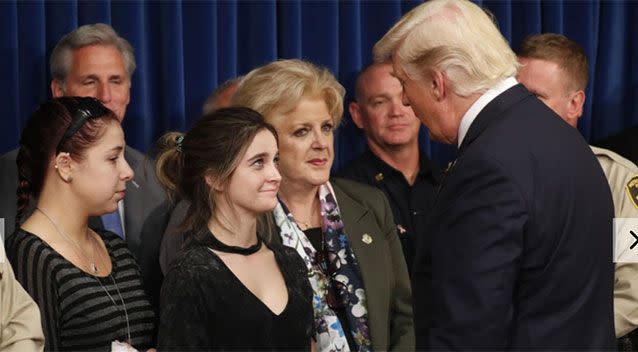 Donald Trump is greeted by survivor family members Shelby Stalker and Stephanie Melanson. Source: Reuters