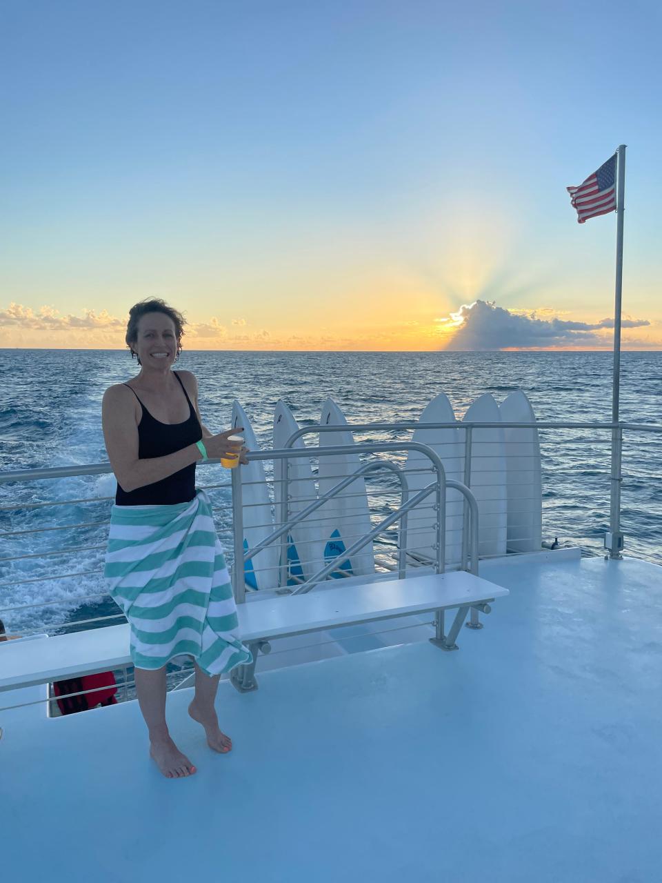 Laura Schmuzter, a woman in a black bathing suit on a boat